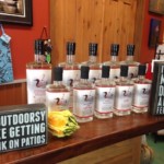 Inside Distillery, 5 large bottles and 5 small bottles lined up for tastings